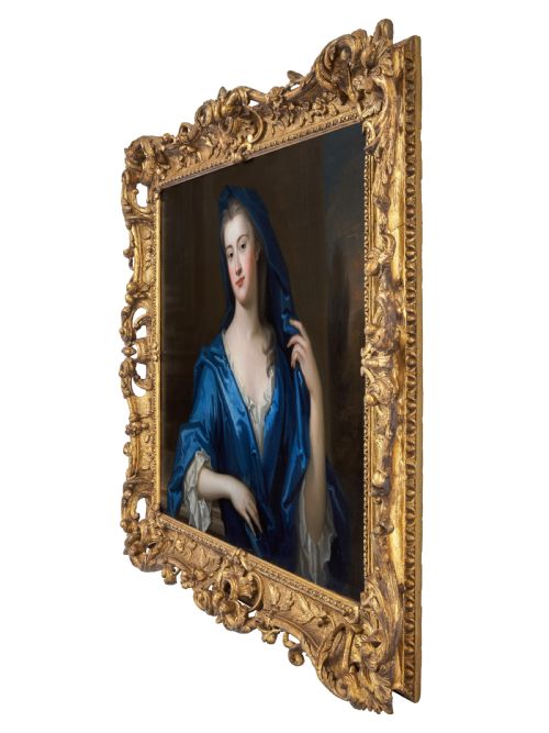 fig 2. An eighteenth-century oil portrait of a lady draped in a blue mantle, set within an intricate carved giltwood frame.