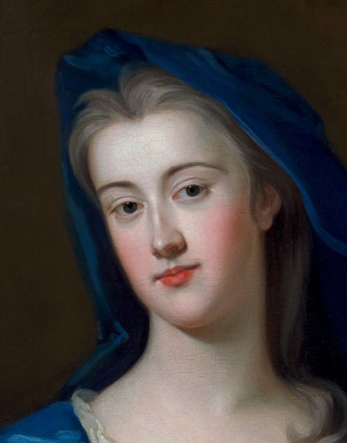 fig 6. An eighteenth-century oil portrait of a lady draped in a blue mantle, set within an intricate carved giltwood frame.