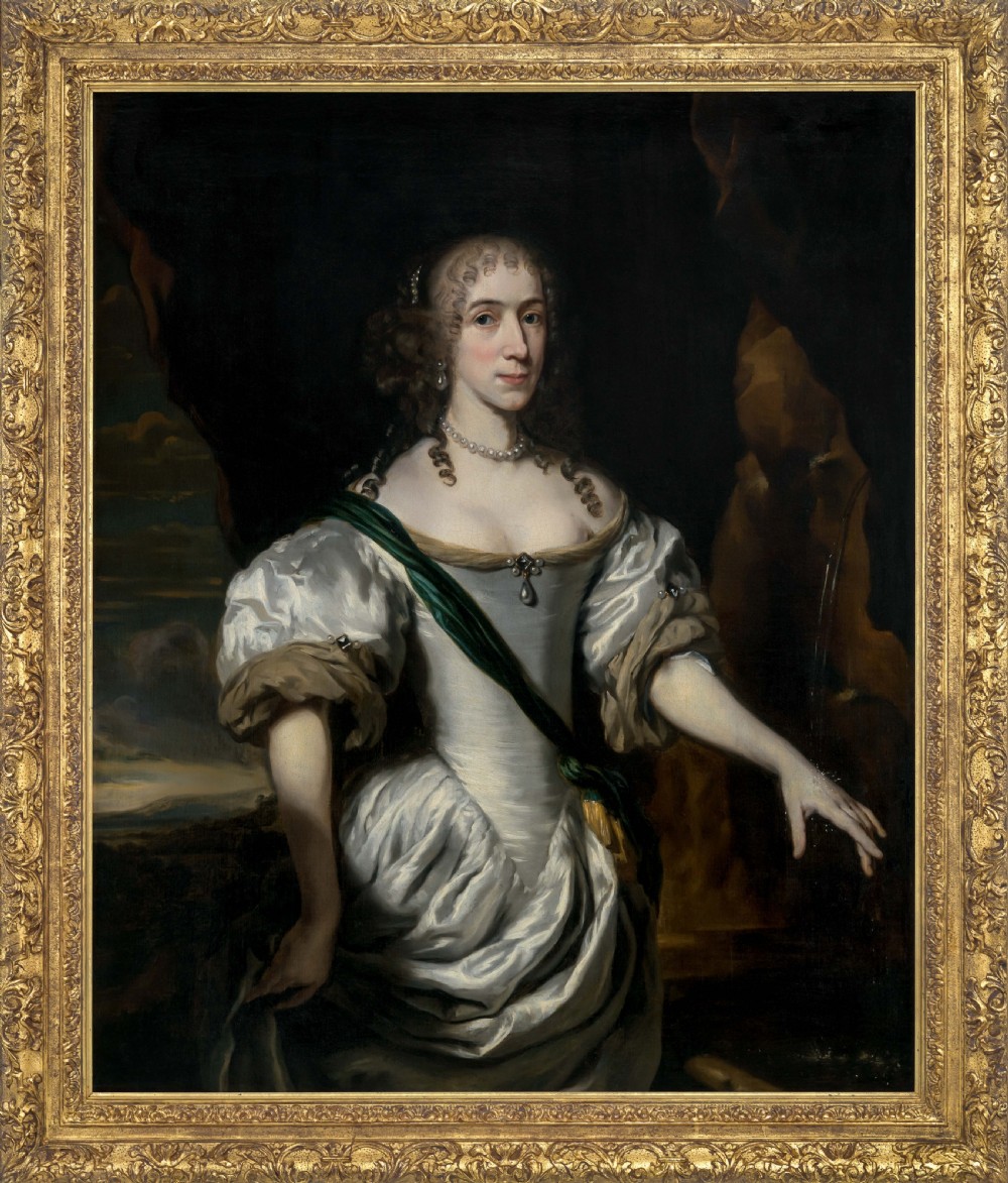 A three-quarter length oil portrait depicting a woman in a white satin gown with a green sash, set within an ornate carved gilded frame.