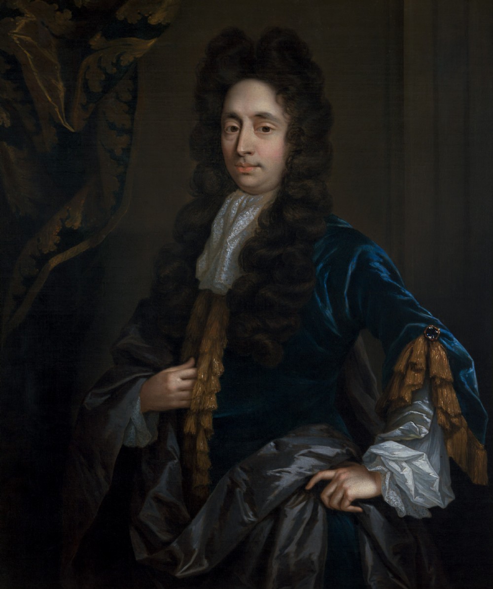 An oil painting of a 17th-century gentleman wearing a dark blue coat, full brown wig, and white lace cravat, set inside an ornate carved gilded frame. View IV