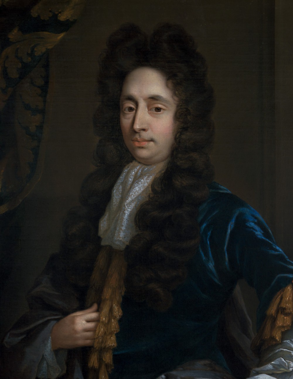 An oil painting of a 17th-century gentleman wearing a dark blue coat, full brown wig, and white lace cravat, set inside an ornate carved gilded frame. View V