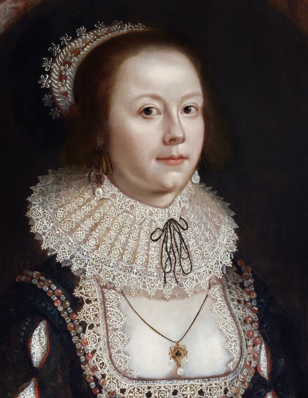 A seventeenth-century oil painting on wood panel depicting a lady in a black dress with an elaborate lace collar, set within a painted oval frame. View V