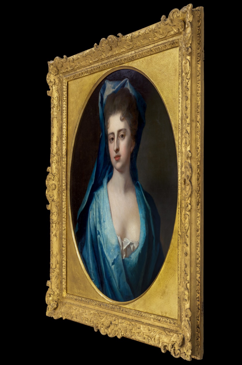 Pair of early eighteenth-century oil portraits on canvas featuring a man and a woman in blue drapery framed in elaborate carved gold giltwood frames. View IV