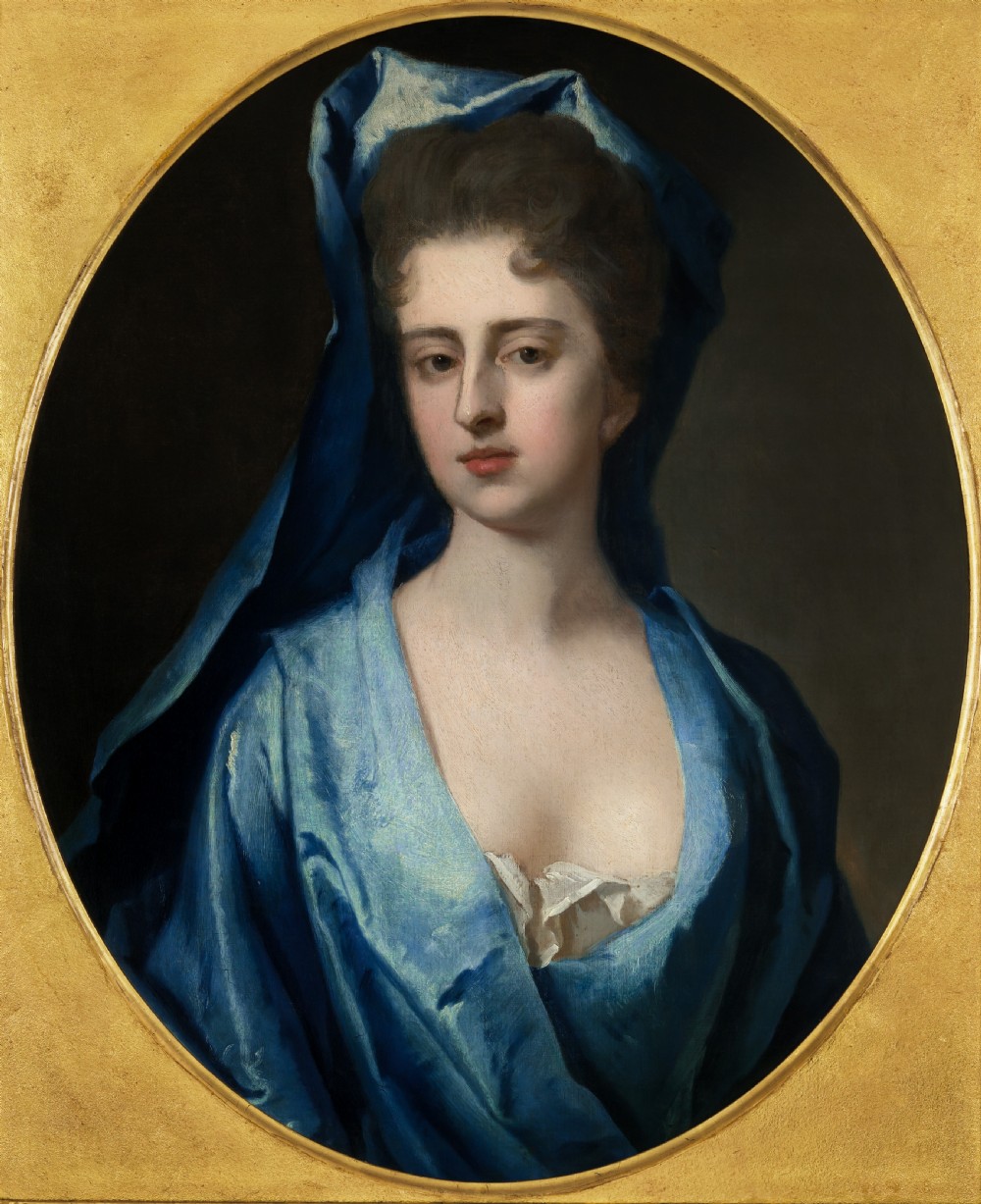 Pair of early eighteenth-century oil portraits on canvas featuring a man and a woman in blue drapery framed in elaborate carved gold giltwood frames. View V
