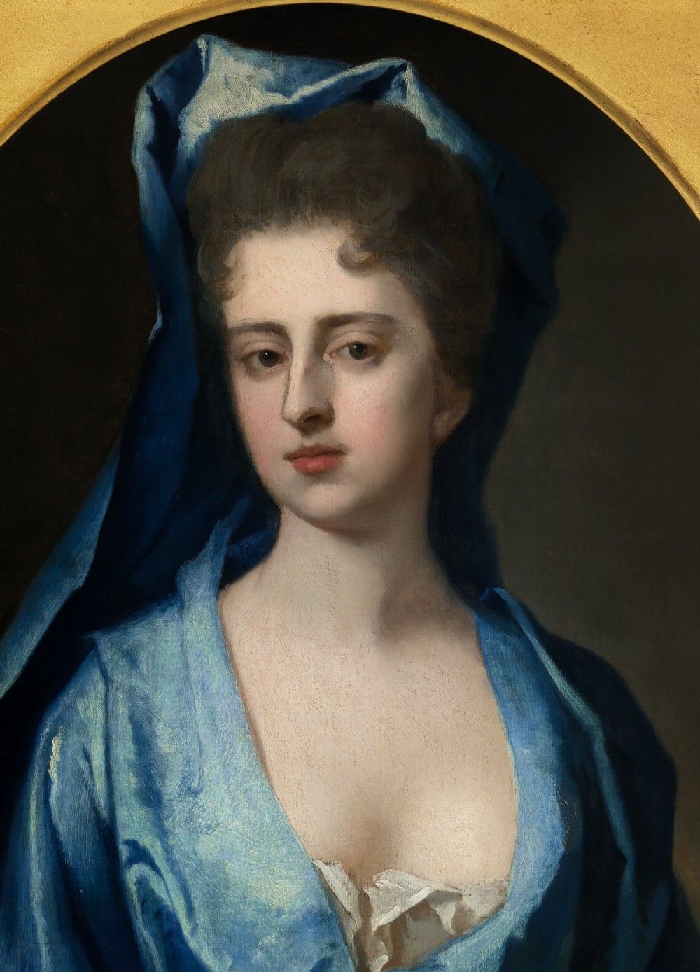 Pair of early eighteenth-century oil portraits on canvas featuring a man and a woman in blue drapery framed in elaborate carved gold giltwood frames. View VI