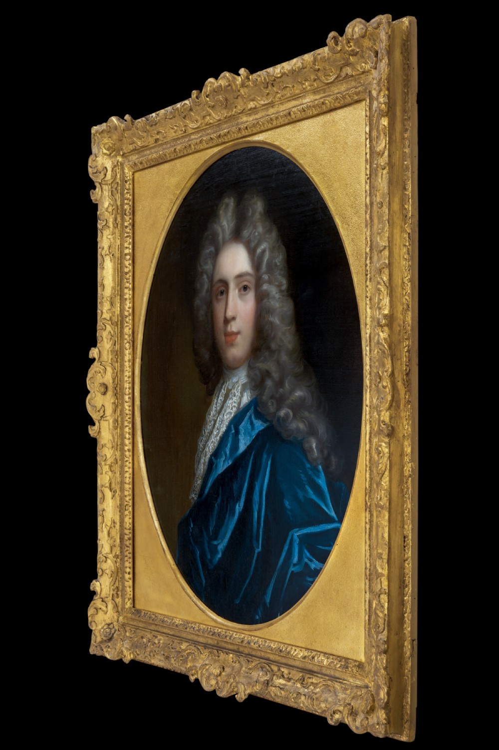 Pair of early eighteenth-century oil portraits on canvas featuring a man and a woman in blue drapery framed in elaborate carved gold giltwood frames. View VIII