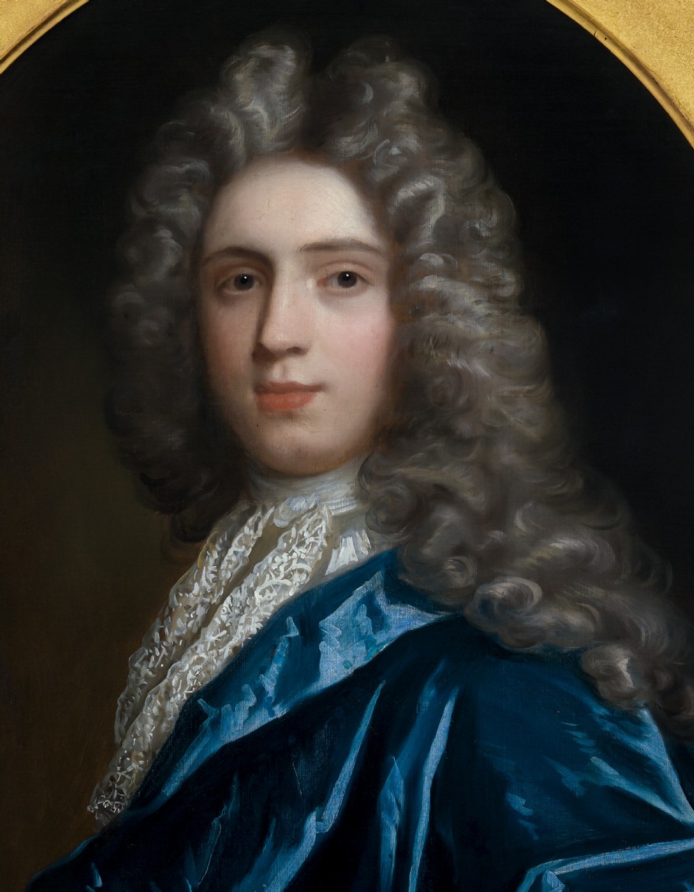 Pair of early eighteenth-century oil portraits on canvas featuring a man and a woman in blue drapery framed in elaborate carved gold giltwood frames. View X