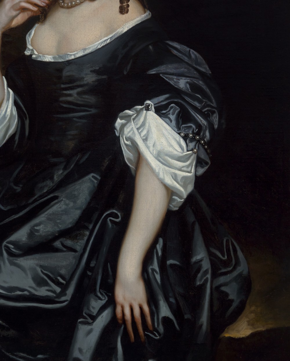 An oil painting depicting a 17th-century woman in a black dress with white satin sleeves and a pearl necklace, set against a dark backdrop with a stone bust sculpture inside a dark frame with gilded corners. View VI