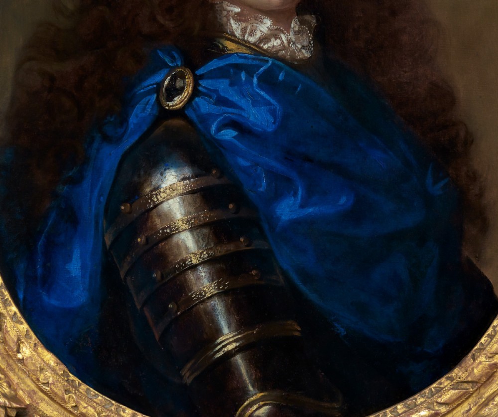 An oval oil painting depicting a gentleman wearing plate armour and an azure blue cloak with a jewelled brooch, set within a carved gold gilt frame. View IV