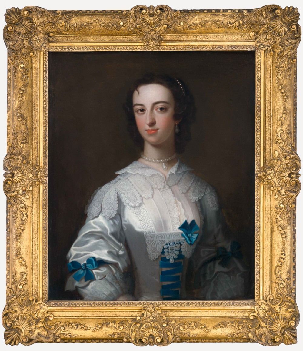 An 18th-century oil portrait depicting a lady in a white silk dress adorned with blue ribbons, housed within a ornate gilded frame.