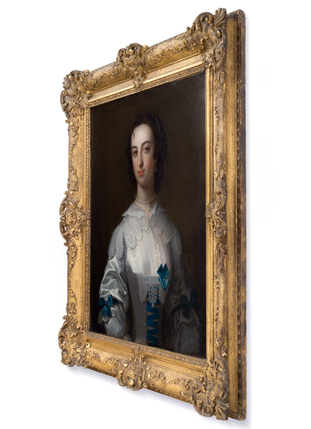 An 18th-century oil portrait depicting a lady in a white silk dress adorned with blue ribbons, housed within a ornate gilded frame. View II