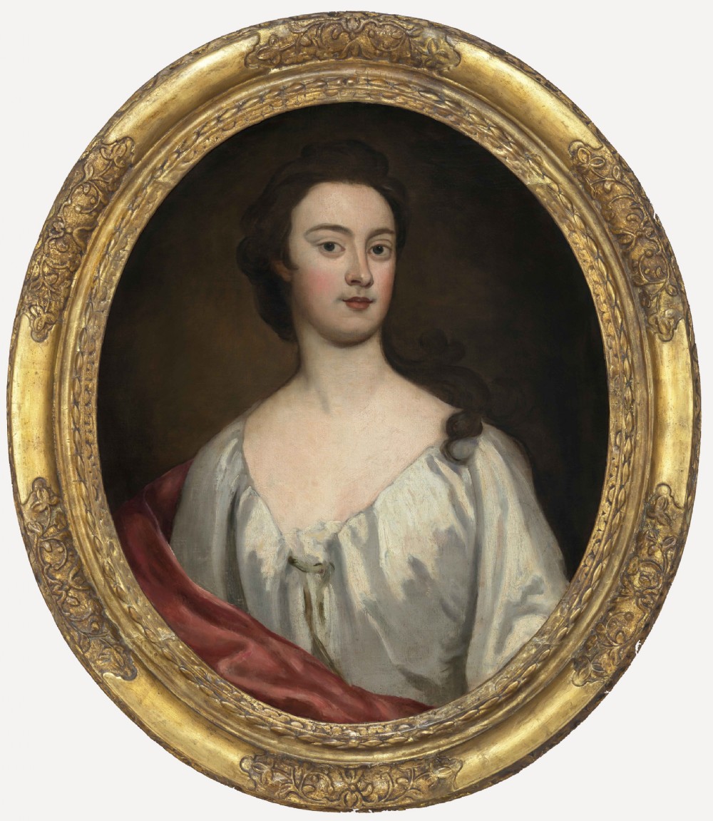An eighteenth-century oval oil portrait depicting a young lady in a white gown and red mantle set inside a carved gilded frame.