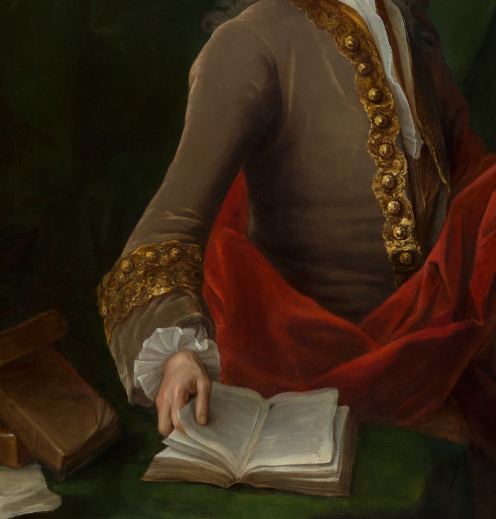 An 18th-century oil portrait depicting a wigged gentleman in a brown coat seated beside open books, enclosed in a carved giltwood frame. View VII