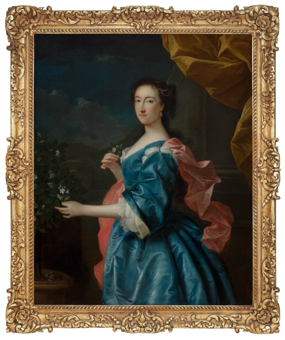 An 18th-century oil painting depicting a woman in a blue satin dress beside a potted orange tree, framed in carved giltwood.
