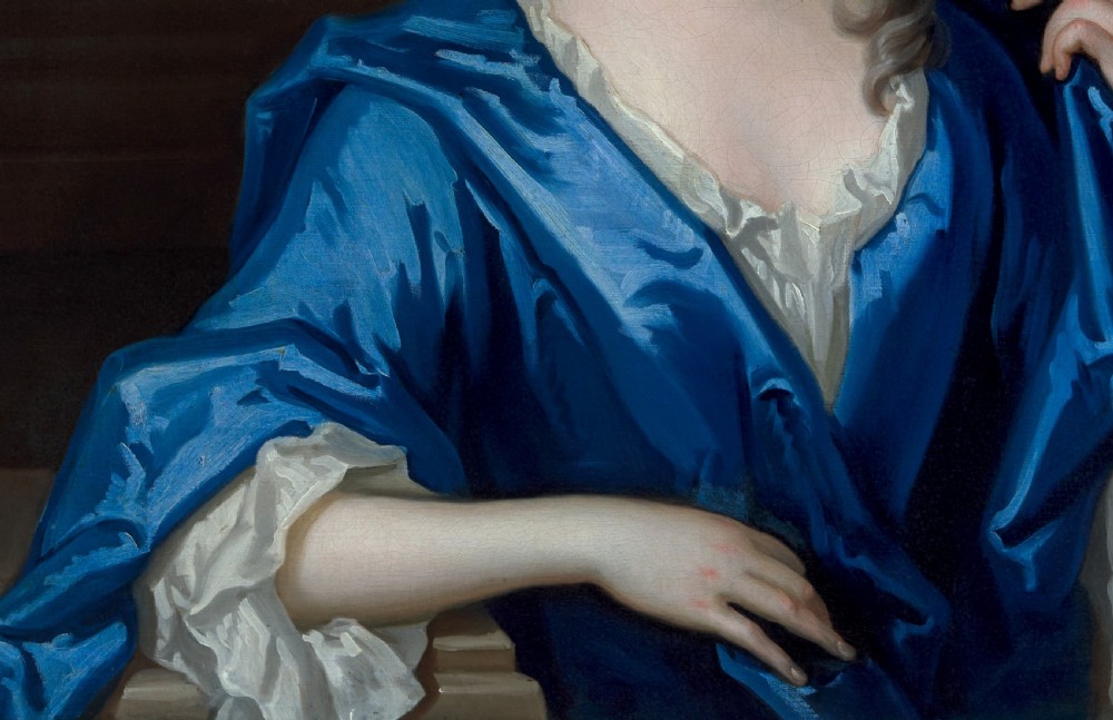 An eighteenth-century oil portrait of a lady draped in a blue mantle, set within an intricate carved giltwood frame. View IX