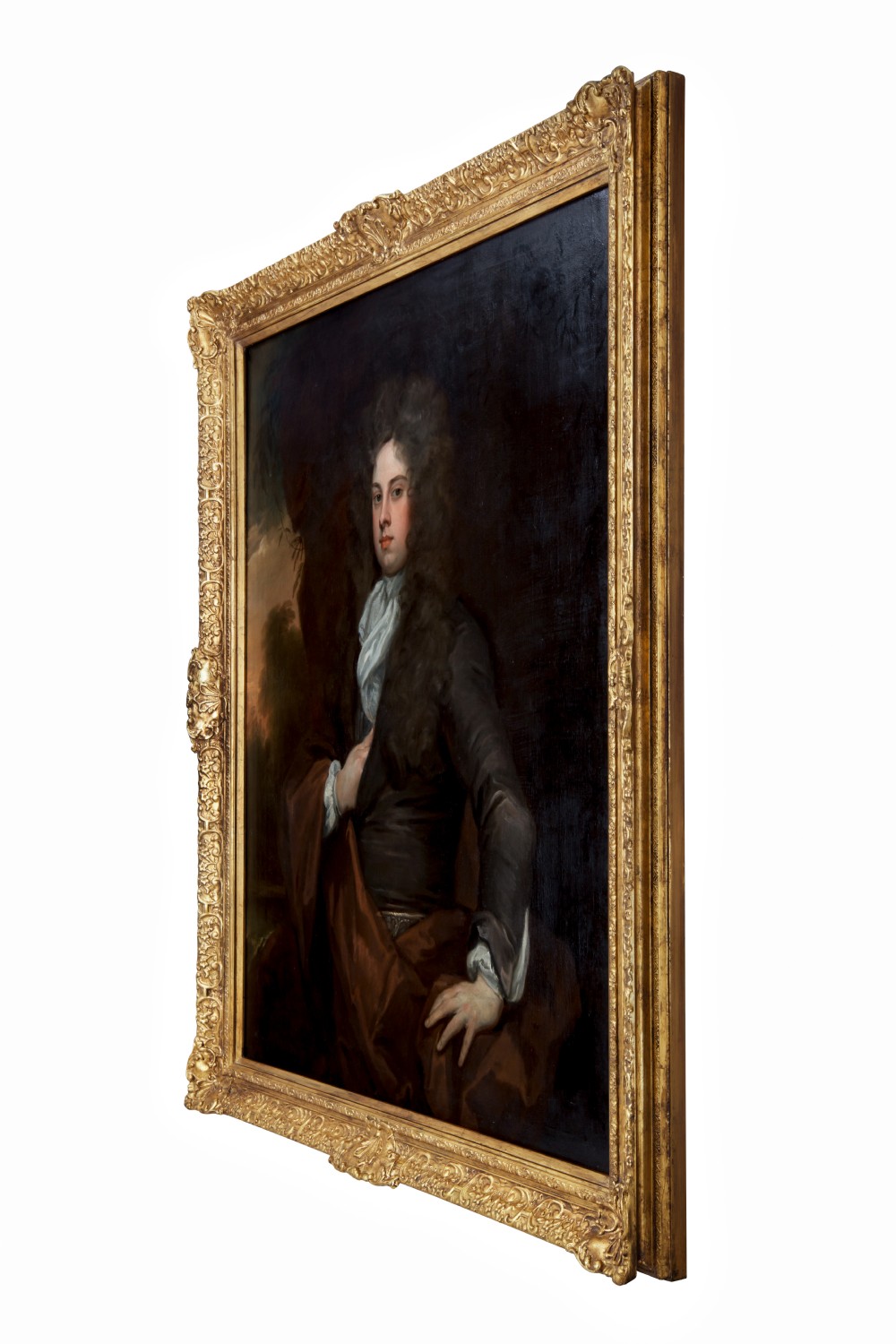 An 18th-century oil portrait depicting a young man in a wig and dark coat within an ornate gold gilt frame. View II