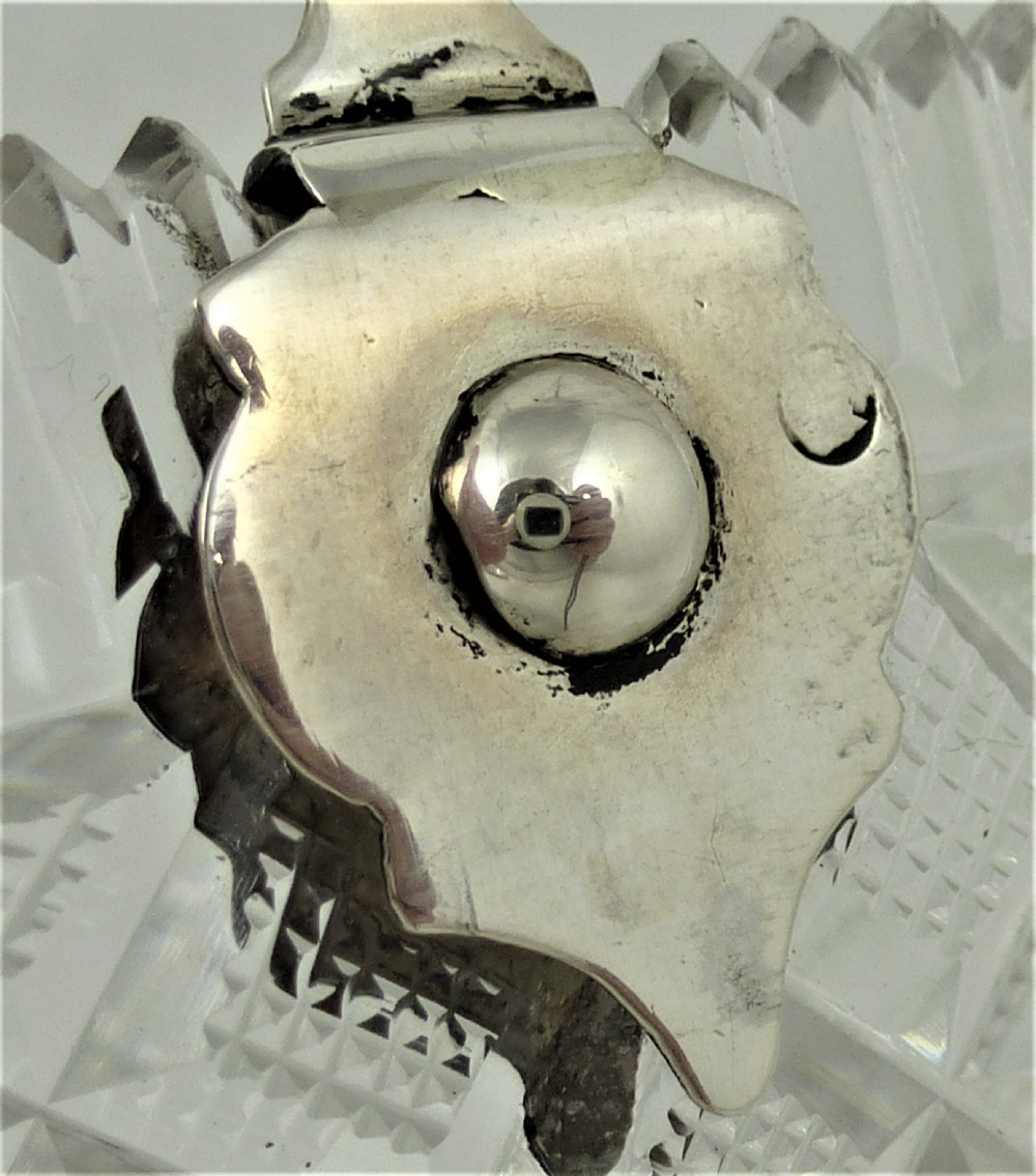 A 19th-century rectangular cut glass basket featuring diamond-patterned faceting and an arched silver swing handle attached to side mounts. View IX