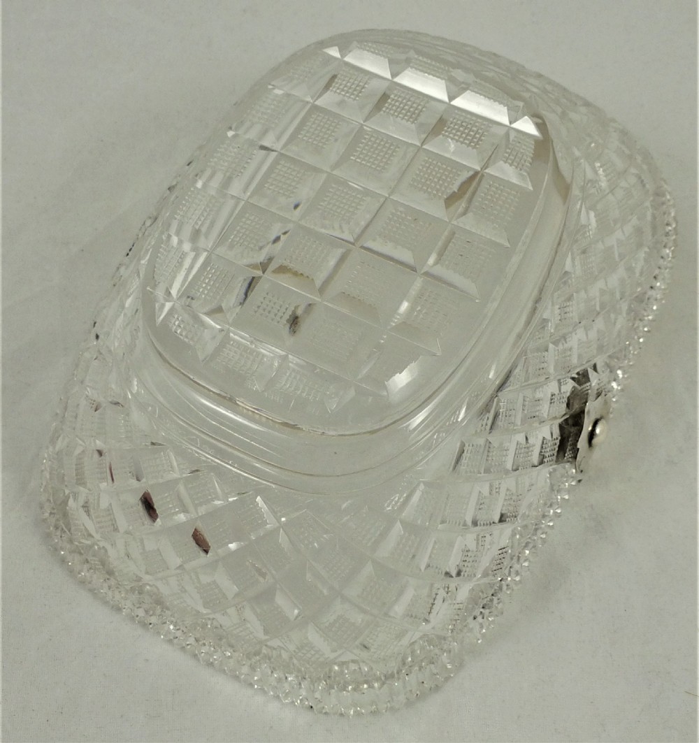 A 19th-century rectangular cut glass basket featuring diamond-patterned faceting and an arched silver swing handle attached to side mounts. View XI