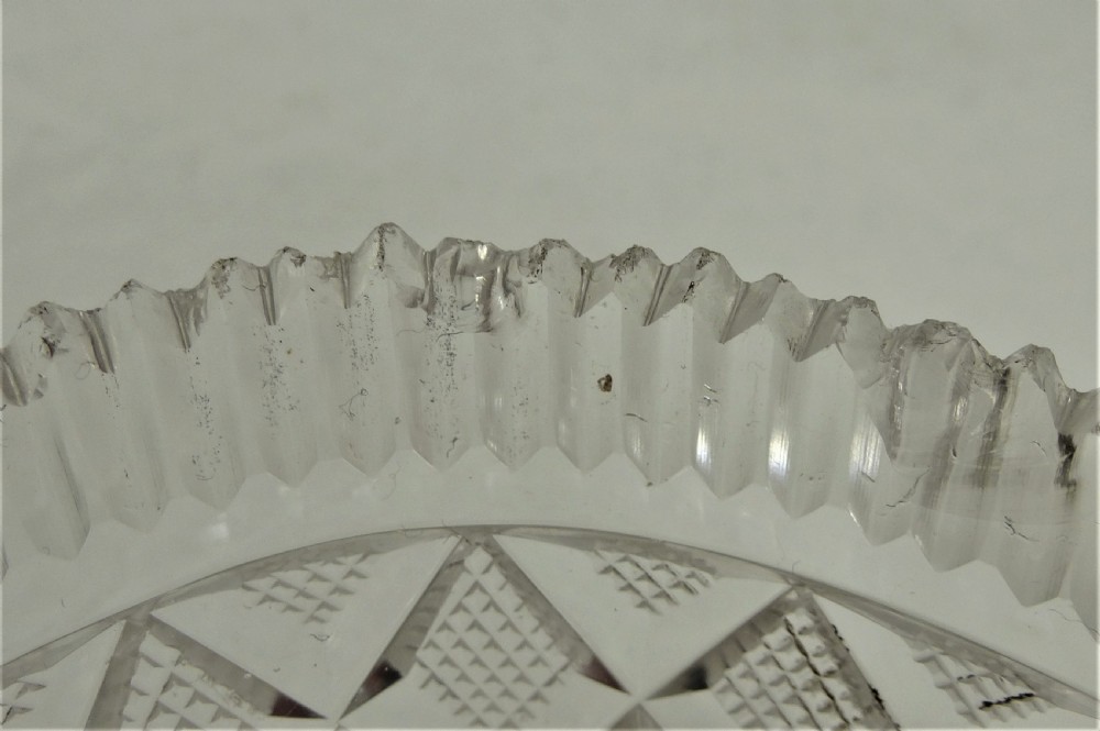 A 19th-century rectangular cut glass basket featuring diamond-patterned faceting and an arched silver swing handle attached to side mounts. View XII