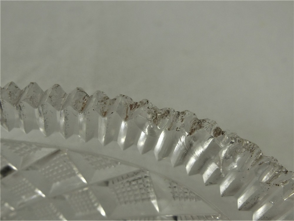 A 19th-century rectangular cut glass basket featuring diamond-patterned faceting and an arched silver swing handle attached to side mounts. View XIV