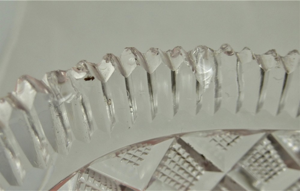 A 19th-century rectangular cut glass basket featuring diamond-patterned faceting and an arched silver swing handle attached to side mounts. View XVI