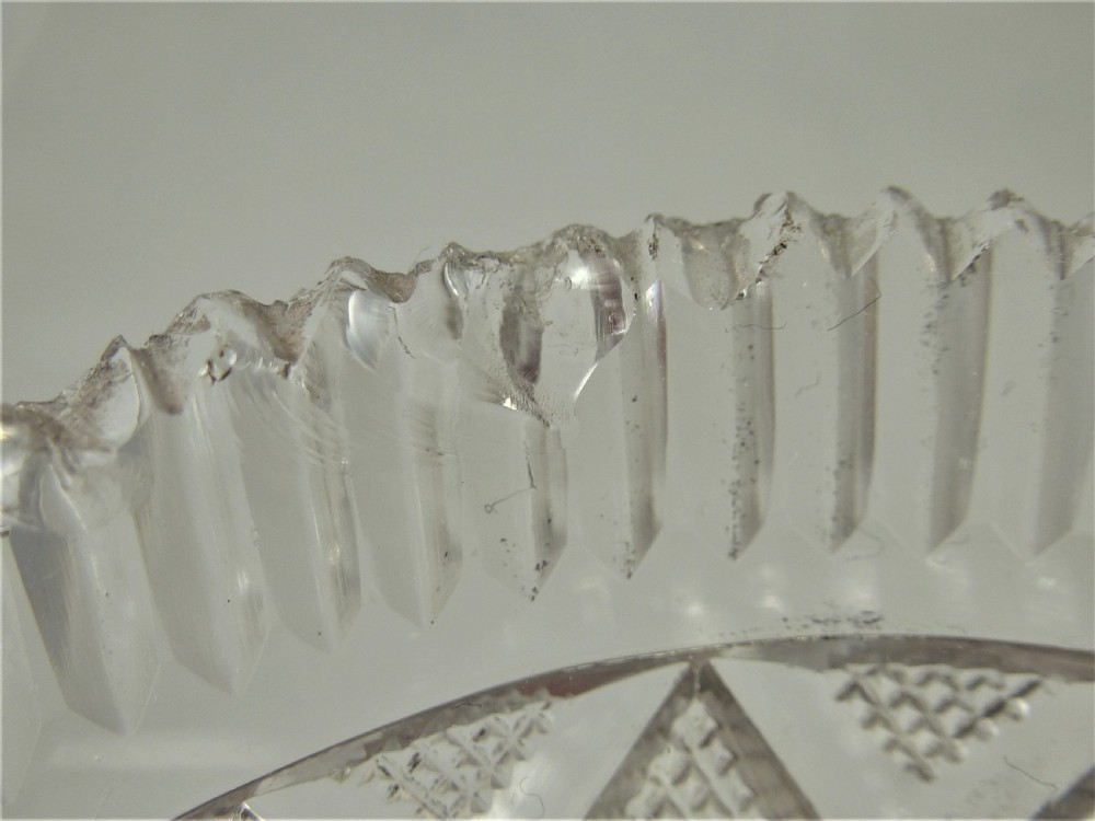 A 19th-century rectangular cut glass basket featuring diamond-patterned faceting and an arched silver swing handle attached to side mounts. View XVII