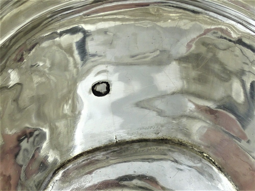 A Victorian sterling silver milk jug featuring gadrooned rim details, engraved geometric scrollwork, a shaped handle, and small ball feet. View XIII