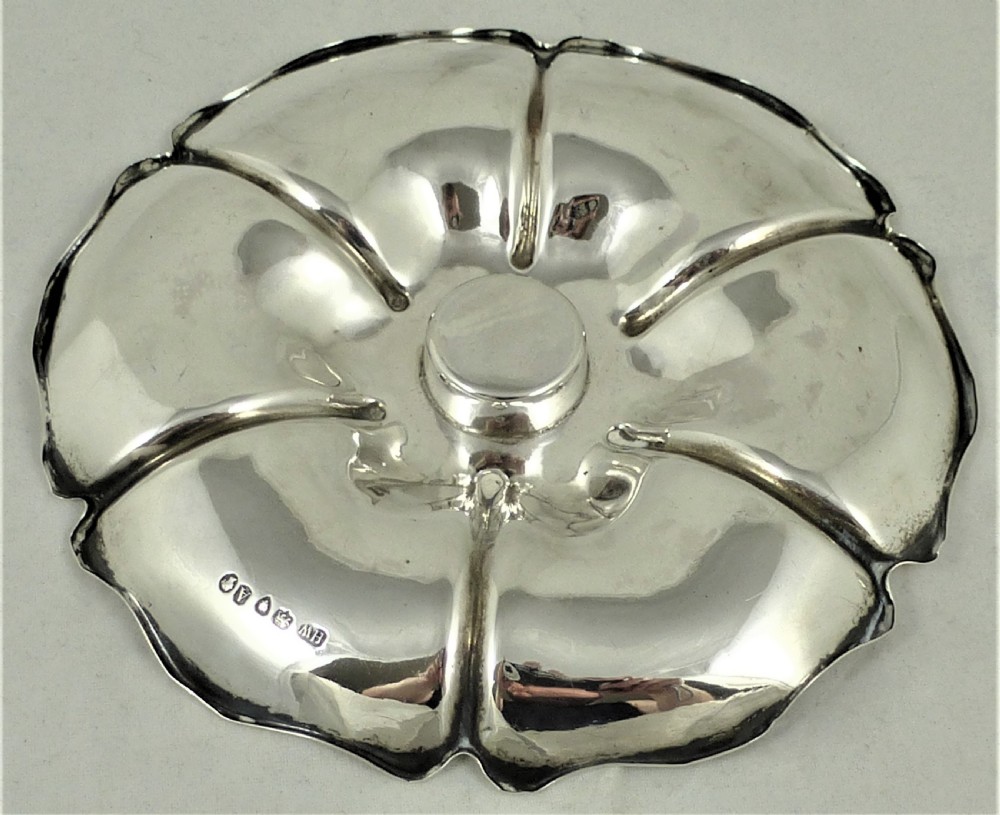 An engraved Victorian sterling silver inkstand featuring a scalloped rim tray and a central cut-glass inkwell with a silver hinged lid. View VII