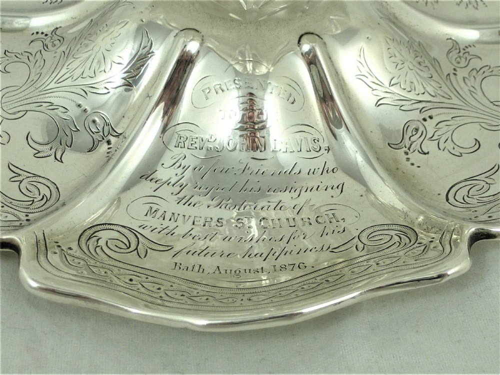 An engraved Victorian sterling silver inkstand featuring a scalloped rim tray and a central cut-glass inkwell with a silver hinged lid. View IX