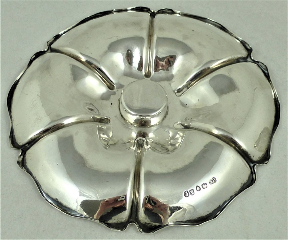 An engraved Victorian sterling silver inkstand featuring a scalloped rim tray and a central cut-glass inkwell with a silver hinged lid. View XI