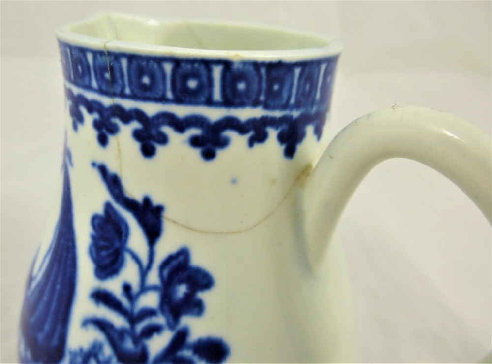 An 18th-century blue and white soft-paste porcelain sparrow beak cream jug with a floral finial lid and Chinoiserie scene. View XI