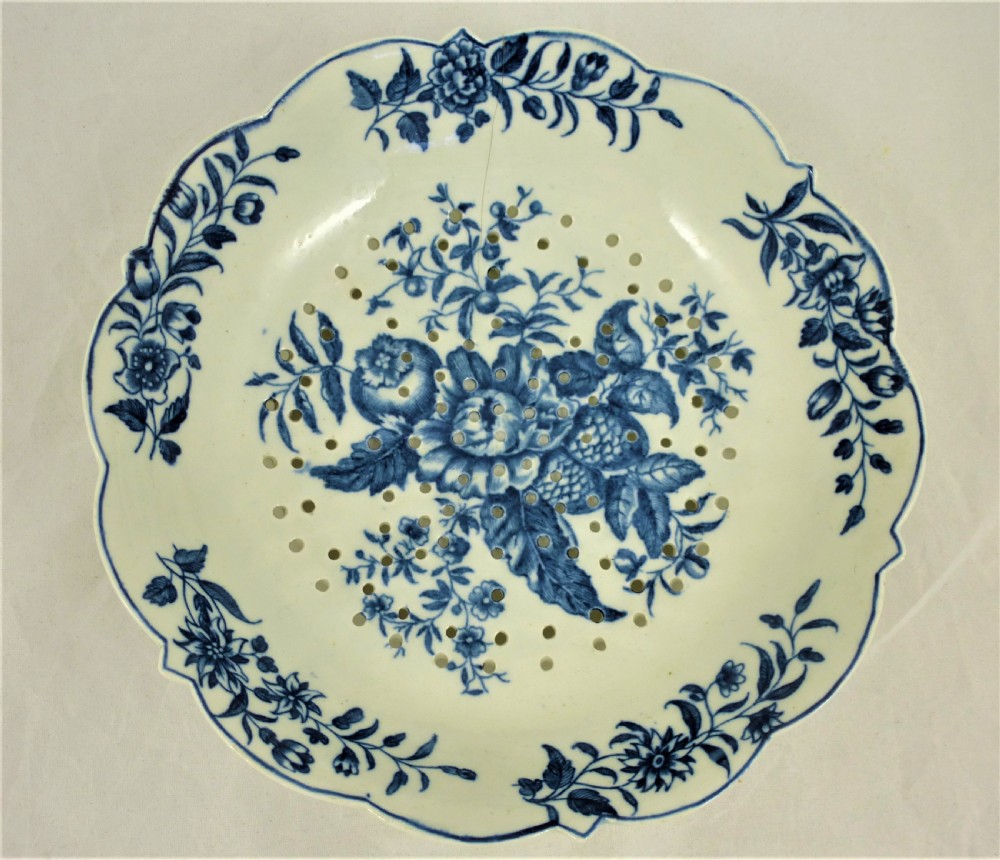 An eighteenth-century blue and white Worcester porcelain strawberry dish with pierced drainage holes resting on a matching scalloped stand. View III