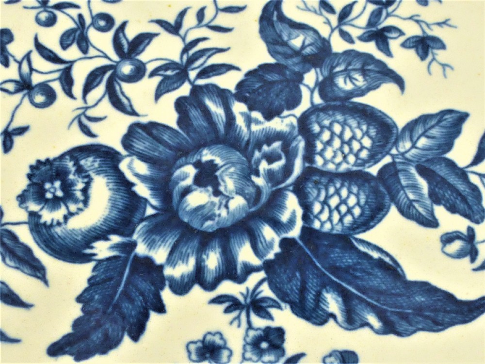 An eighteenth-century blue and white Worcester porcelain strawberry dish with pierced drainage holes resting on a matching scalloped stand. View IV