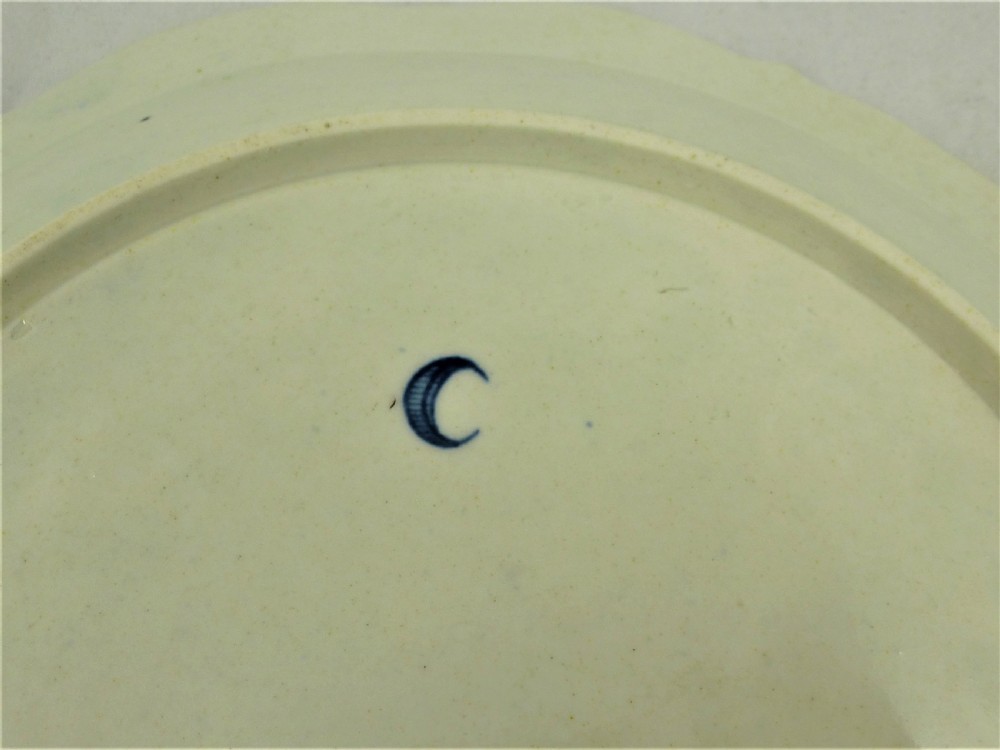 An eighteenth-century blue and white Worcester porcelain strawberry dish with pierced drainage holes resting on a matching scalloped stand. View VII