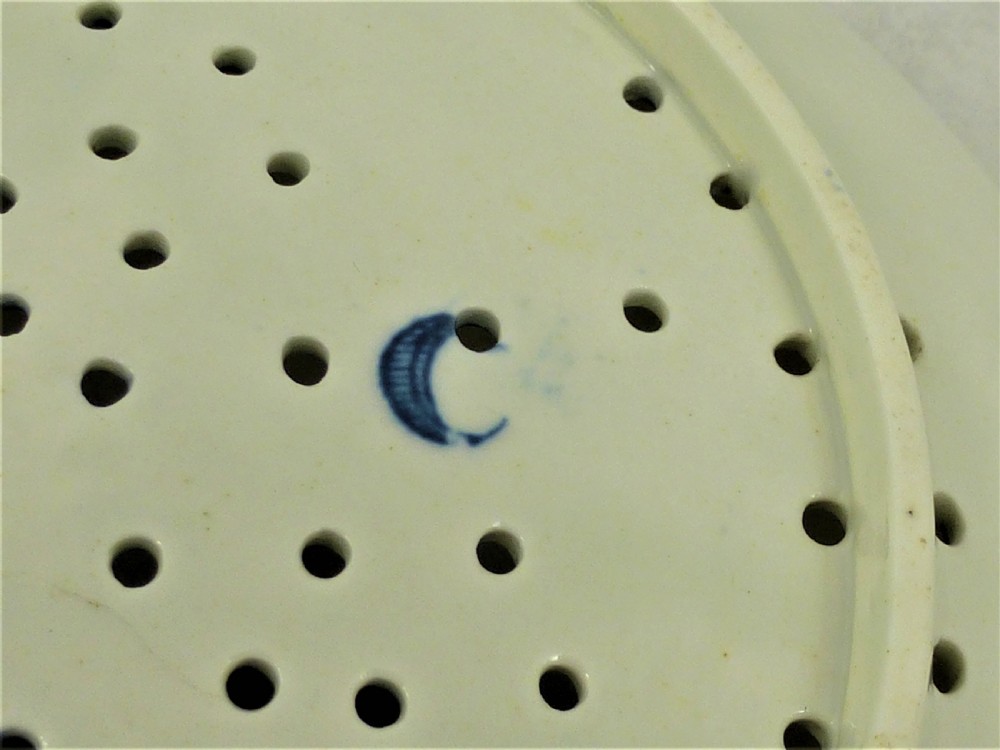 An eighteenth-century blue and white Worcester porcelain strawberry dish with pierced drainage holes resting on a matching scalloped stand. View XII