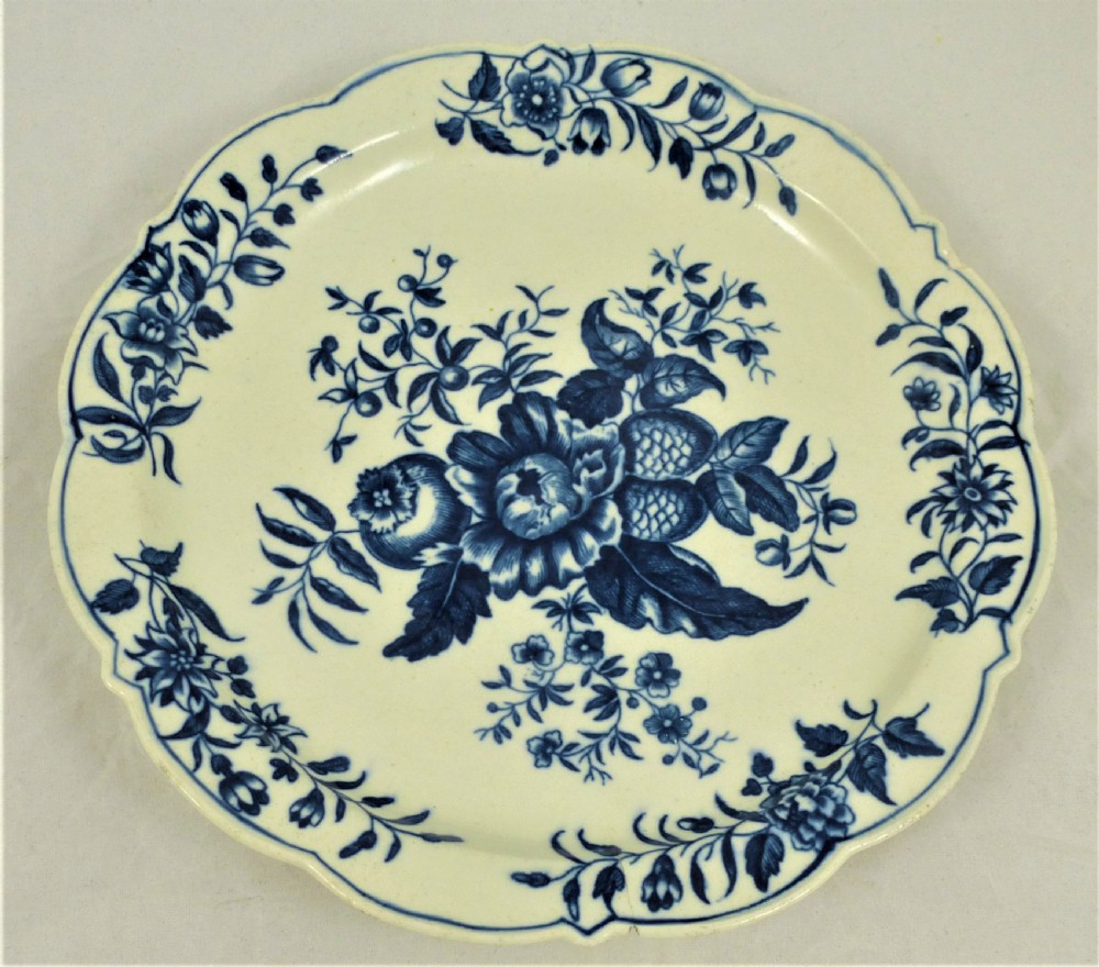 An eighteenth-century blue and white Worcester porcelain strawberry dish with pierced drainage holes resting on a matching scalloped stand. View XIII