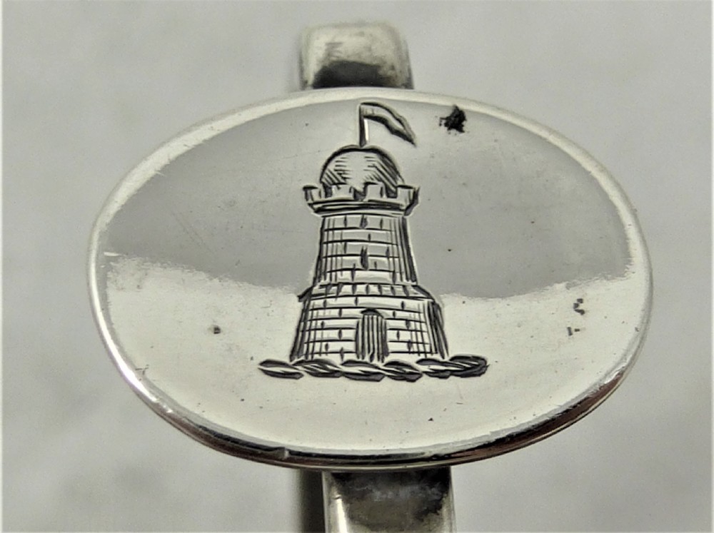 A Victorian silver cruet stand featuring three pierced octagonal compartments, small ball feet, an angled central loop handle, and one clear glass insert. View II