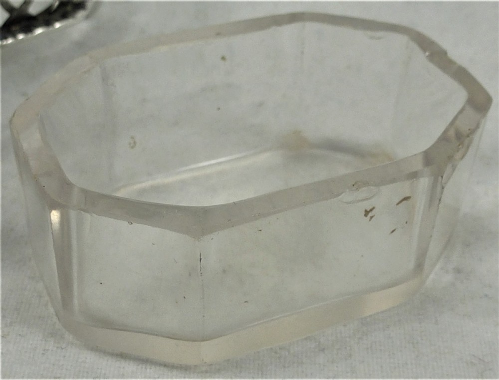 A Victorian silver cruet stand featuring three pierced octagonal compartments, small ball feet, an angled central loop handle, and one clear glass insert. View III