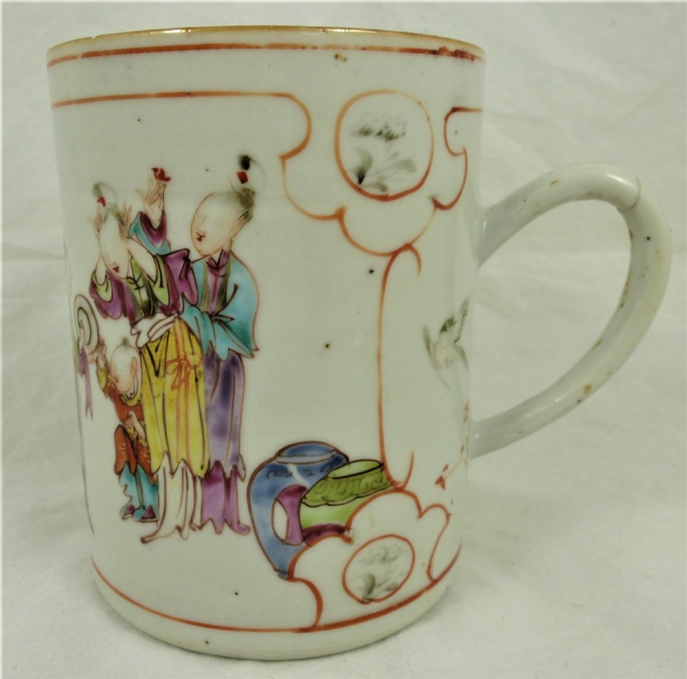 A cylindrical Chinese export porcelain mug featuring hand-painted polychrome figures and floral cartouche borders with a single loop handle.