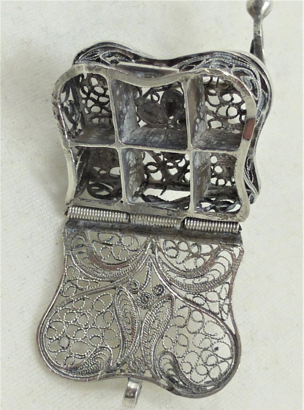 A 19th-century silver filigree miniature table featuring intricate openwork scrollwork and slender legs. View II