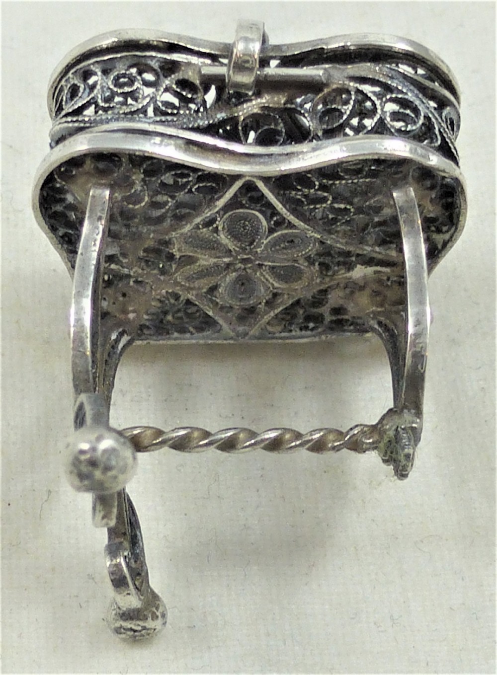 A 19th-century silver filigree miniature table featuring intricate openwork scrollwork and slender legs. View III