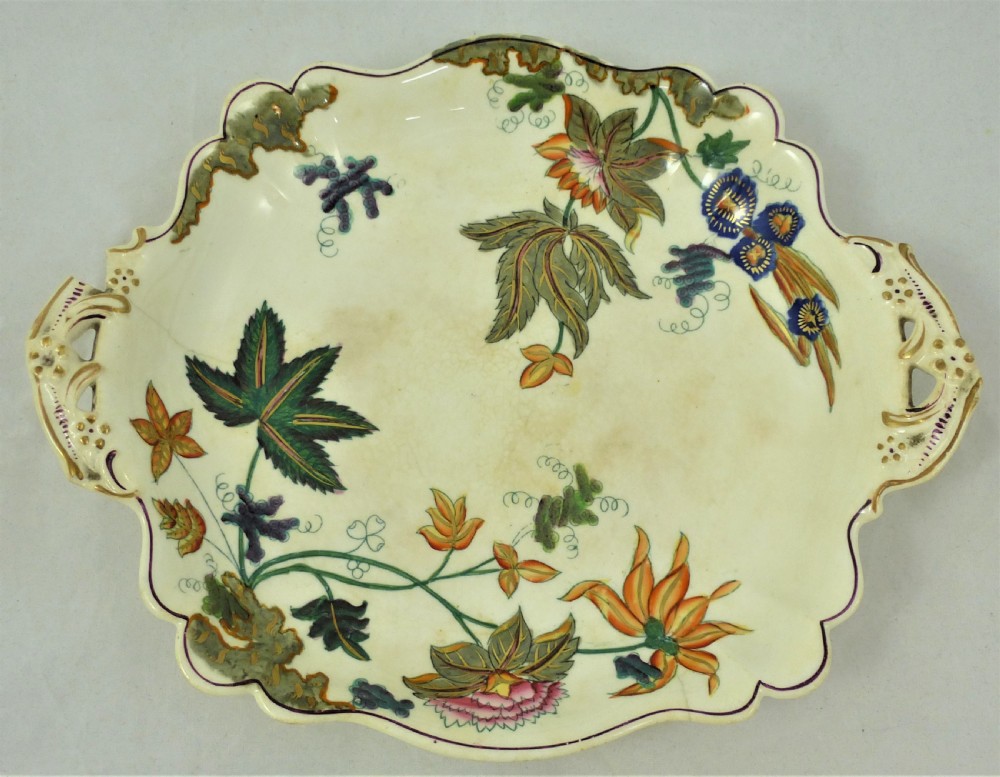 A five-piece English Rococo porcelain dessert service featuring cream-coloured shaped dishes hand-painted with green foliage, floral motifs, and gilt scalloped rims. View III