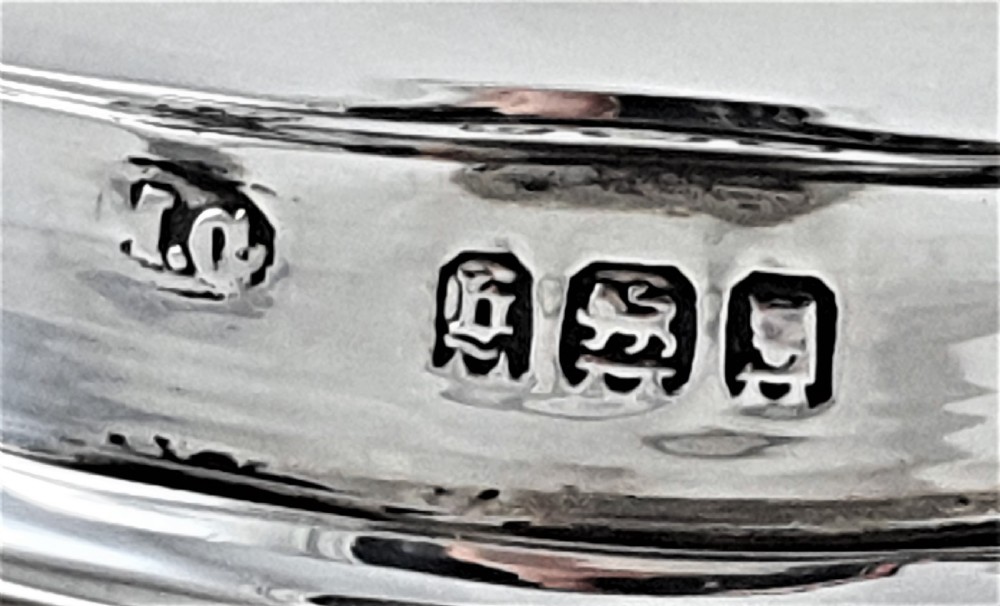 A tapered clear cut-glass sugar shaker featuring etched floral motifs and a domed, perforated silver cap. View XIII