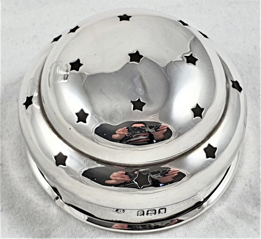 A tapered clear cut-glass sugar shaker featuring etched floral motifs and a domed, perforated silver cap. View XVI