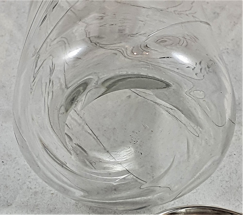 A tapered clear cut-glass sugar shaker featuring etched floral motifs and a domed, perforated silver cap. View XVIII