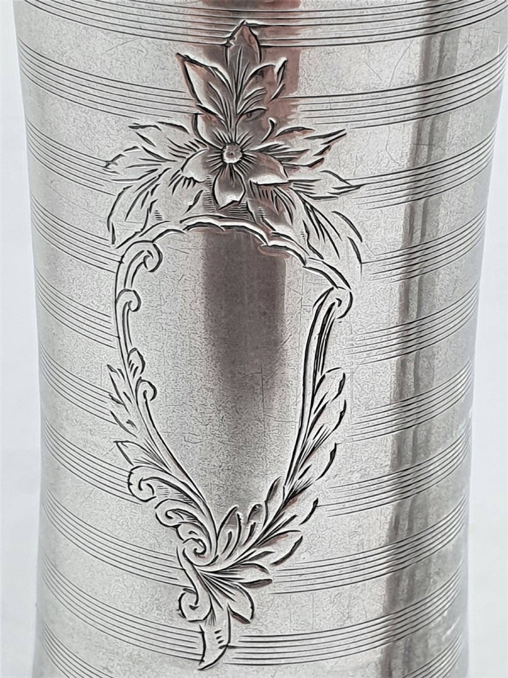A pair of slender sterling silver trumpet vases featuring scalloped rims, horizontal reeded decoration, and central engraved floral cartouches. View IV
