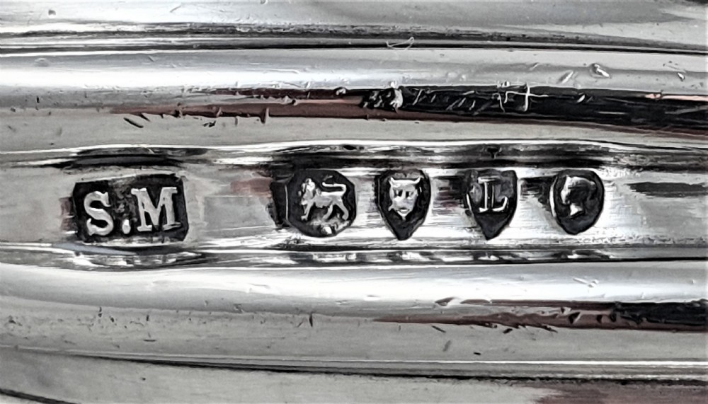 A Victorian sterling silver double-ended scent bottle with spiral fluted decoration, featuring a hinged lid with a glass stopper on one side and a detached screw cap on the other. View III