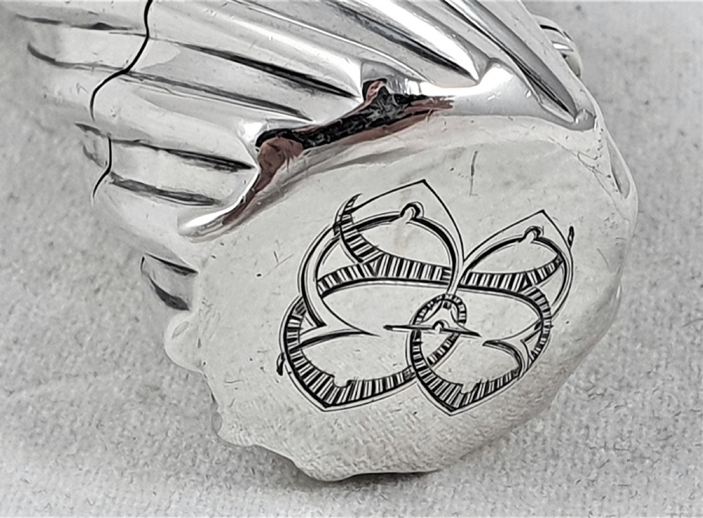 A Victorian sterling silver double-ended scent bottle with spiral fluted decoration, featuring a hinged lid with a glass stopper on one side and a detached screw cap on the other. View IV