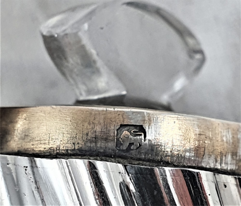 A Victorian sterling silver double-ended scent bottle with spiral fluted decoration, featuring a hinged lid with a glass stopper on one side and a detached screw cap on the other. View XII