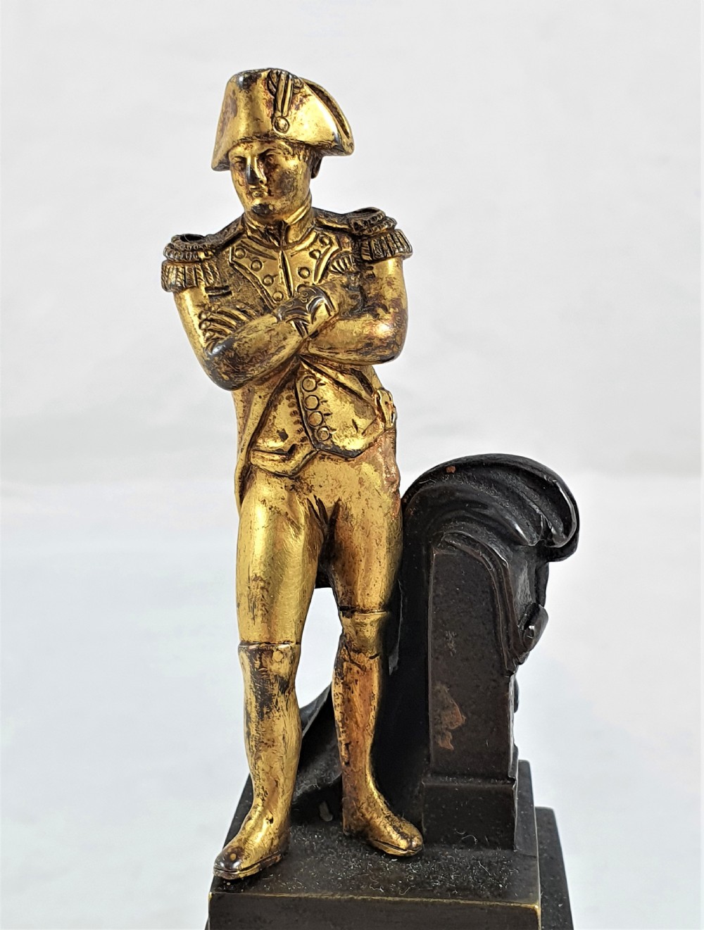 A late nineteenth-century French bronze statuette depicting Napoleon Bonaparte with arms crossed standing on a dark pedestal featuring a gilt eagle motif. View VII